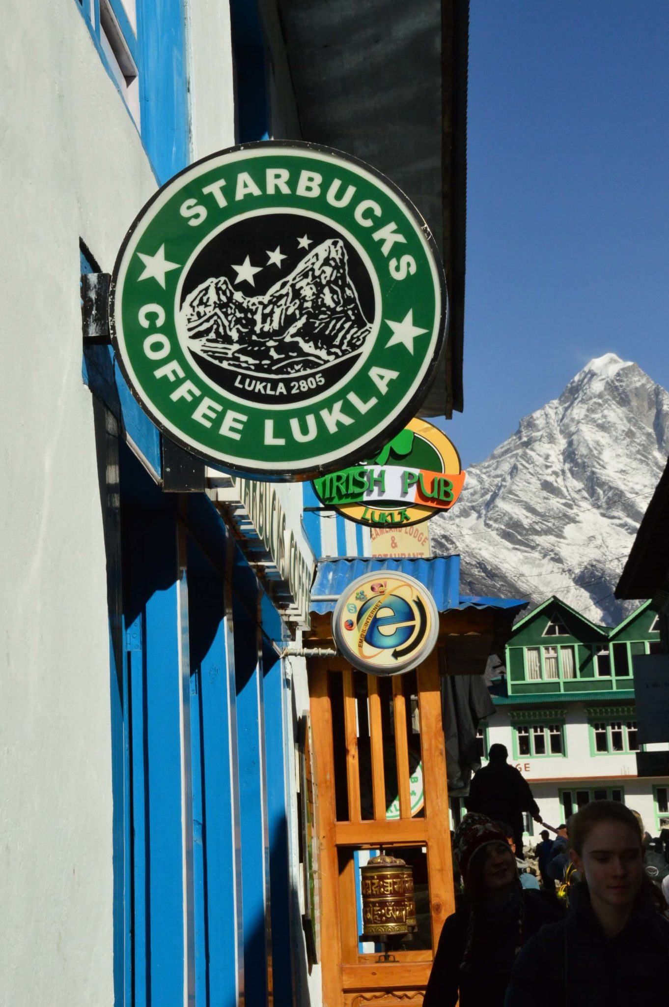 a sign for starbucks lukla on the everest base camp trek