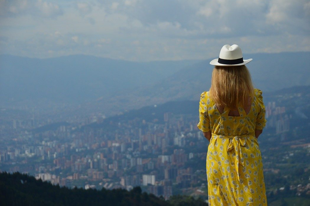 Perfect Colombia Itinerary 2 Weeks including the Rainbow River 22 woman in yellow dress look over medellin