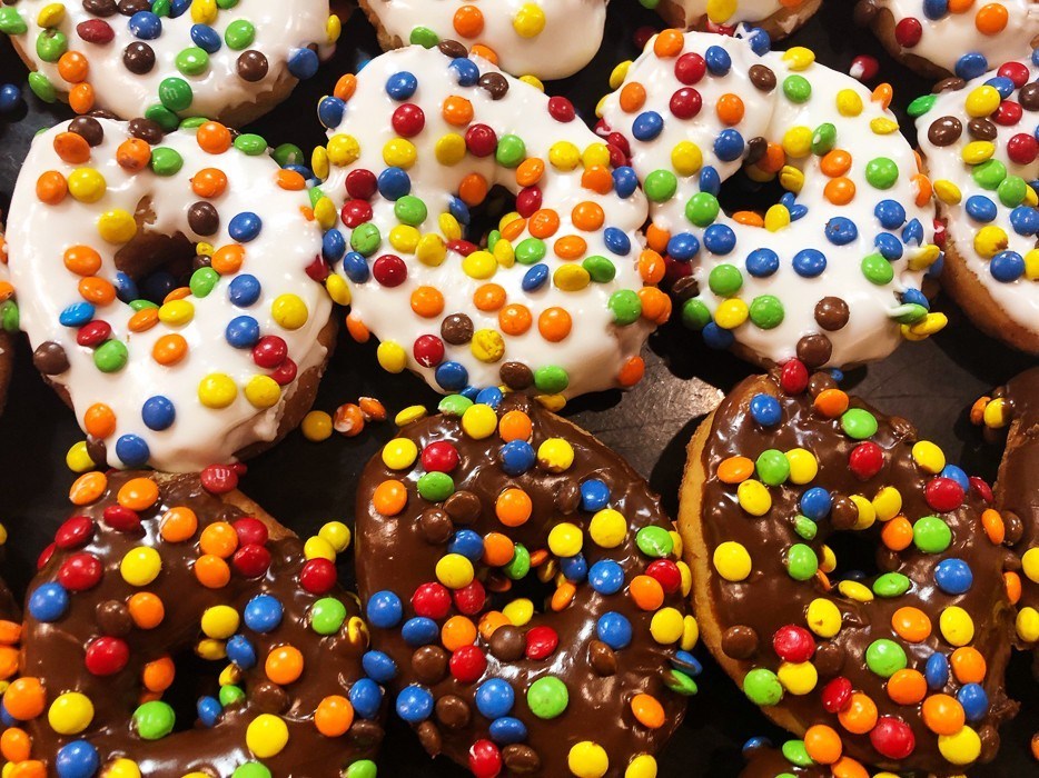 donuts with choclate icing and colourful candies