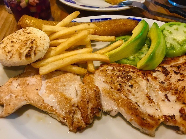 Perfect Colombia Itinerary 2 Weeks including the Rainbow River 16 grilled chicken, chips and avocado on a plate