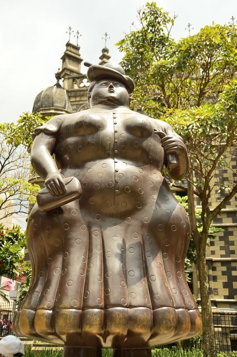 Botero scultpure of woman in hat in botero plaza