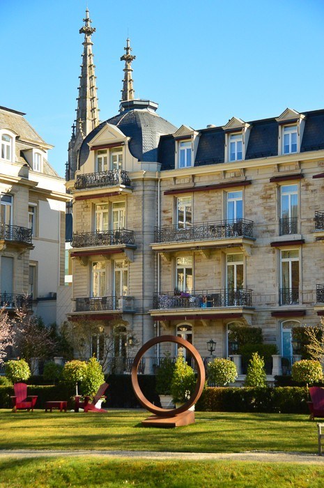 Exterior of Brenners Park Hotel and Spa Baden Baden with sculpture on garden