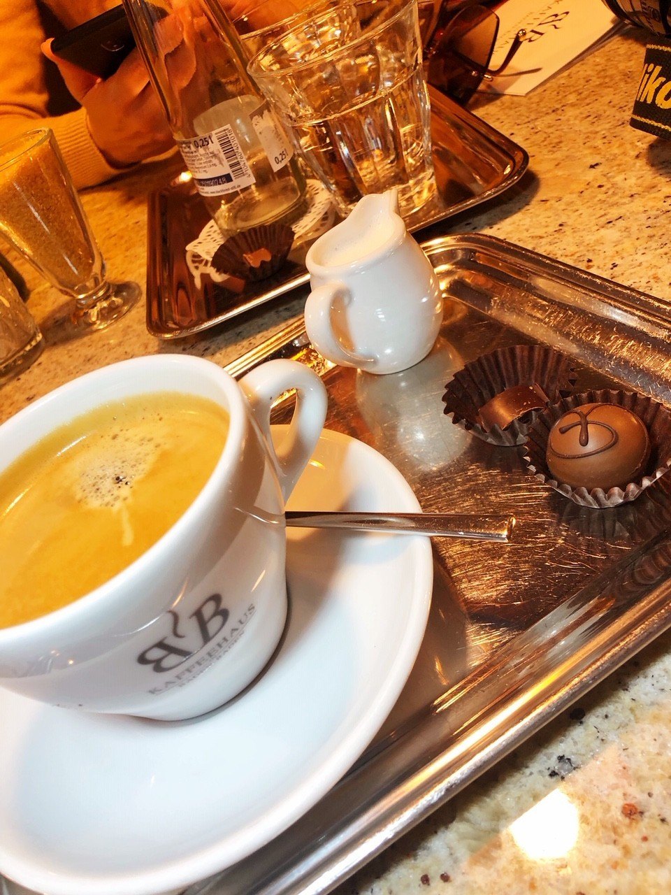 Baden-Baden Spa Guide: Naked or Clothed? (2022) 26 white cup of coffee and saucer on silver tray with milk and chocolates