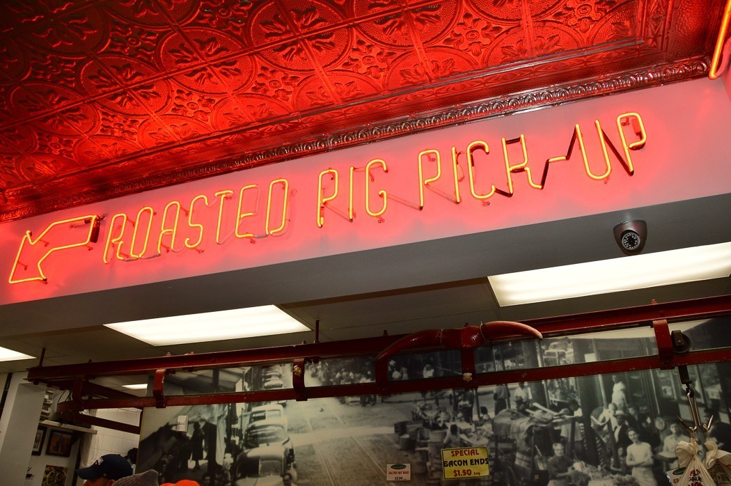 roasted pig pick up sign in the italian market in philadelphia