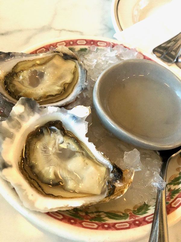 5 Best Places to Stay in Melbourne for Boutique Hotel Lovers 31 oysters on a plate with a light sauce