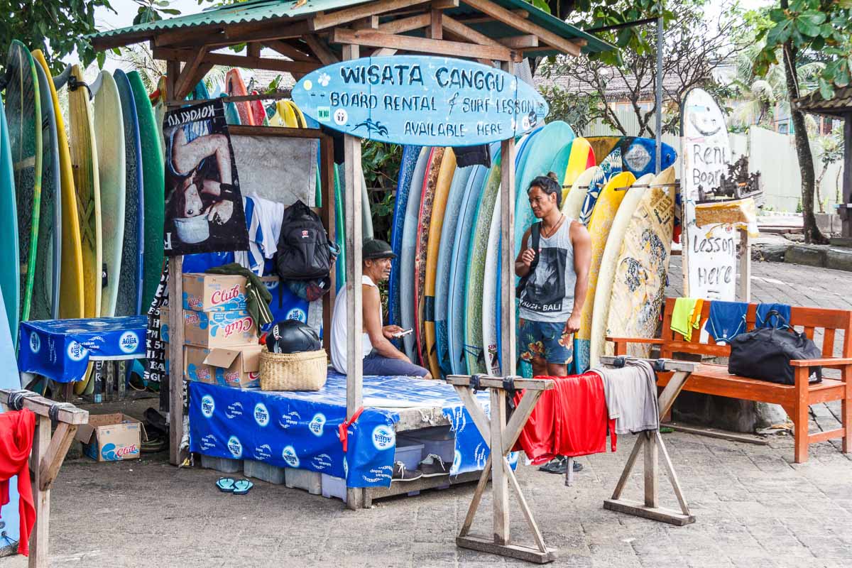 10 Days Itinerary Bali: What you Can't Miss & Must Do 30 Canggu, Bali - 28th May 2017: two people talking at surfboard rental stall. The area is very popular with surfers.