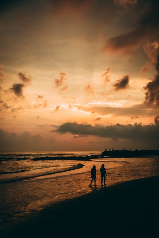 10 Days Itinerary Bali: What you Can't Miss & Must Do 34 couple walking on the beach at sunset in canggu bali