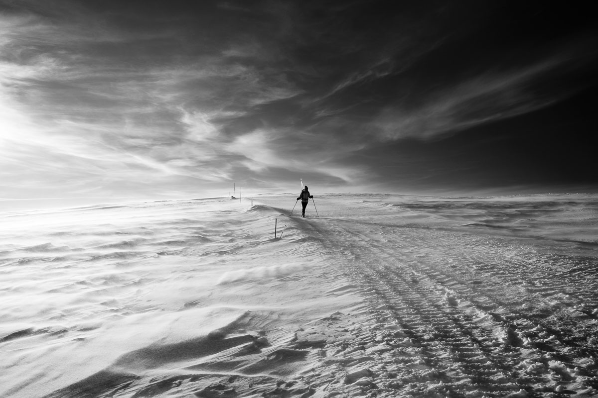 Ultimate Singles Ski Holiday Guide 10 figure of person in distance on a snowy plain in black and white