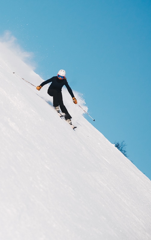 person skiing down a mountain on an angle