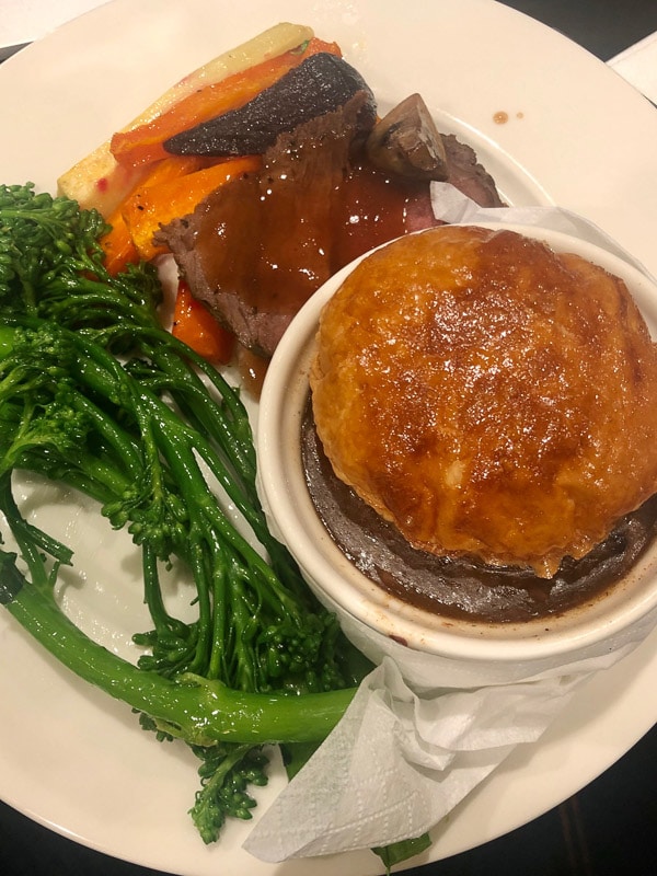 Emirates Business Class Review: Is it Worth It? 30 pastry topped pie and vegetables on plate at perth emirates loun