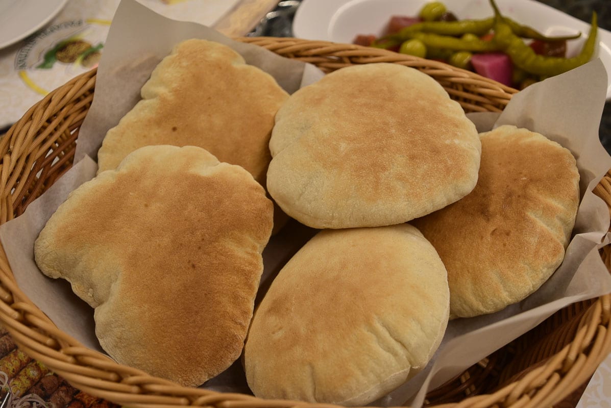 plump pita breads in a basket