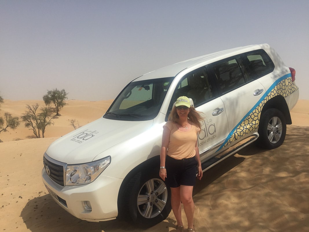 9 Exciting Morning Desert Safari Dubai Tours For Adventurers 8 woman in front of 4 wd in desert