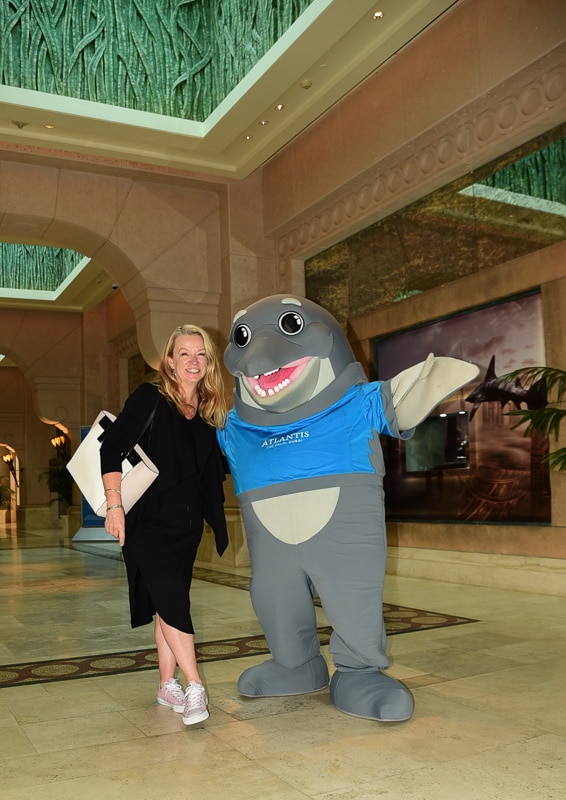 Editorial Policy 1 woman with person in dolphin costume at Palm Jumeirah Atlantis D