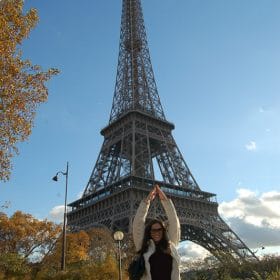woman in front of eiffel tower posing