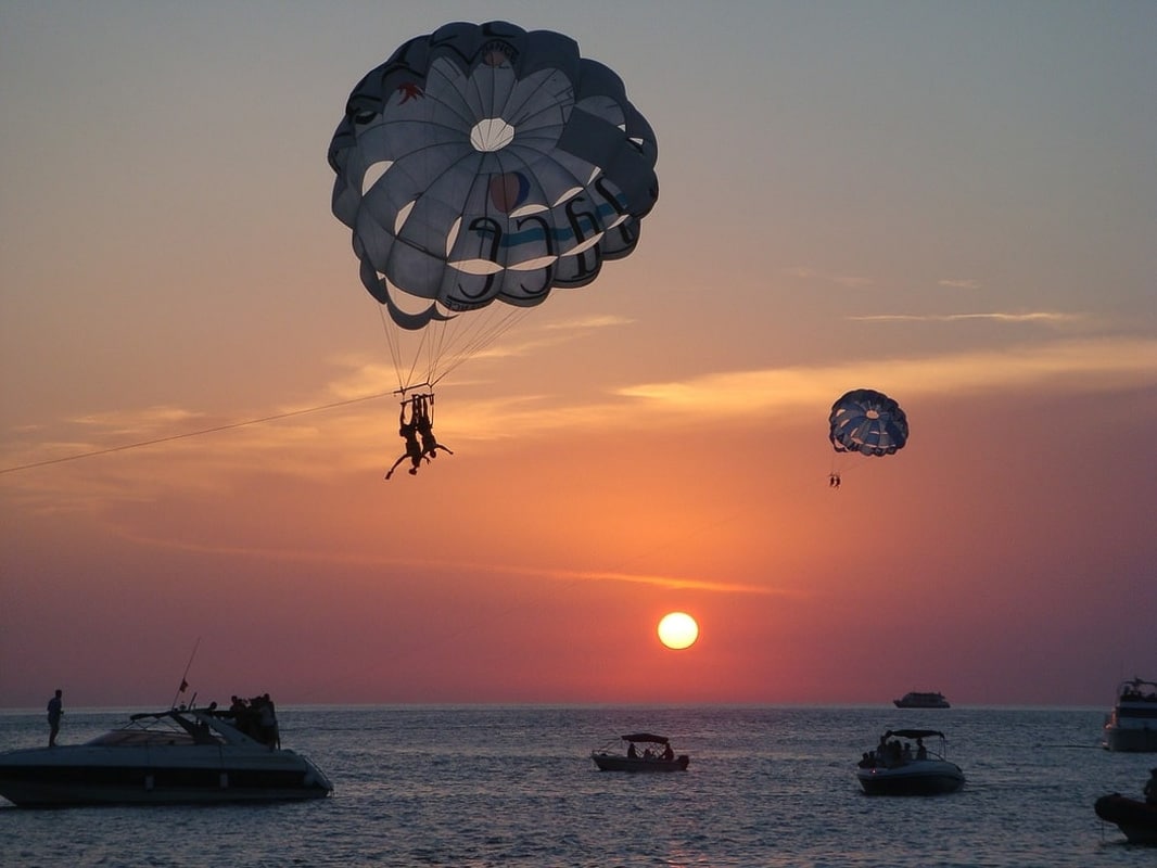 13 Spectacular Sunsets in Ibiza You Won't Want to Miss (2022) 6 ibiza_sunsets with parachuter