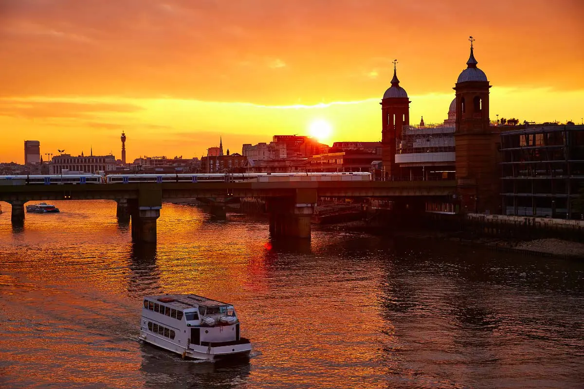 boat on the thames at sunset in london