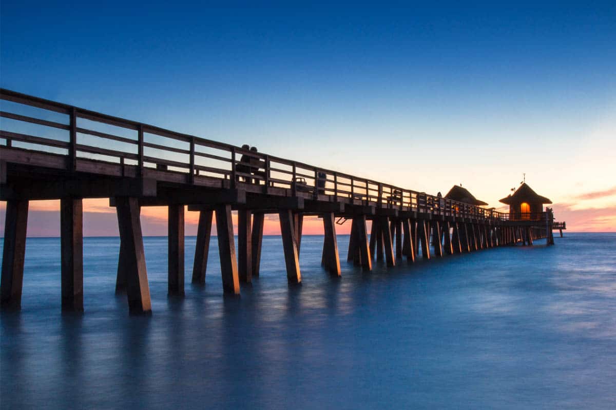 36 Warm Winter Getaways in the USA (2023) You'll Love 37 naples pier florida at sunset