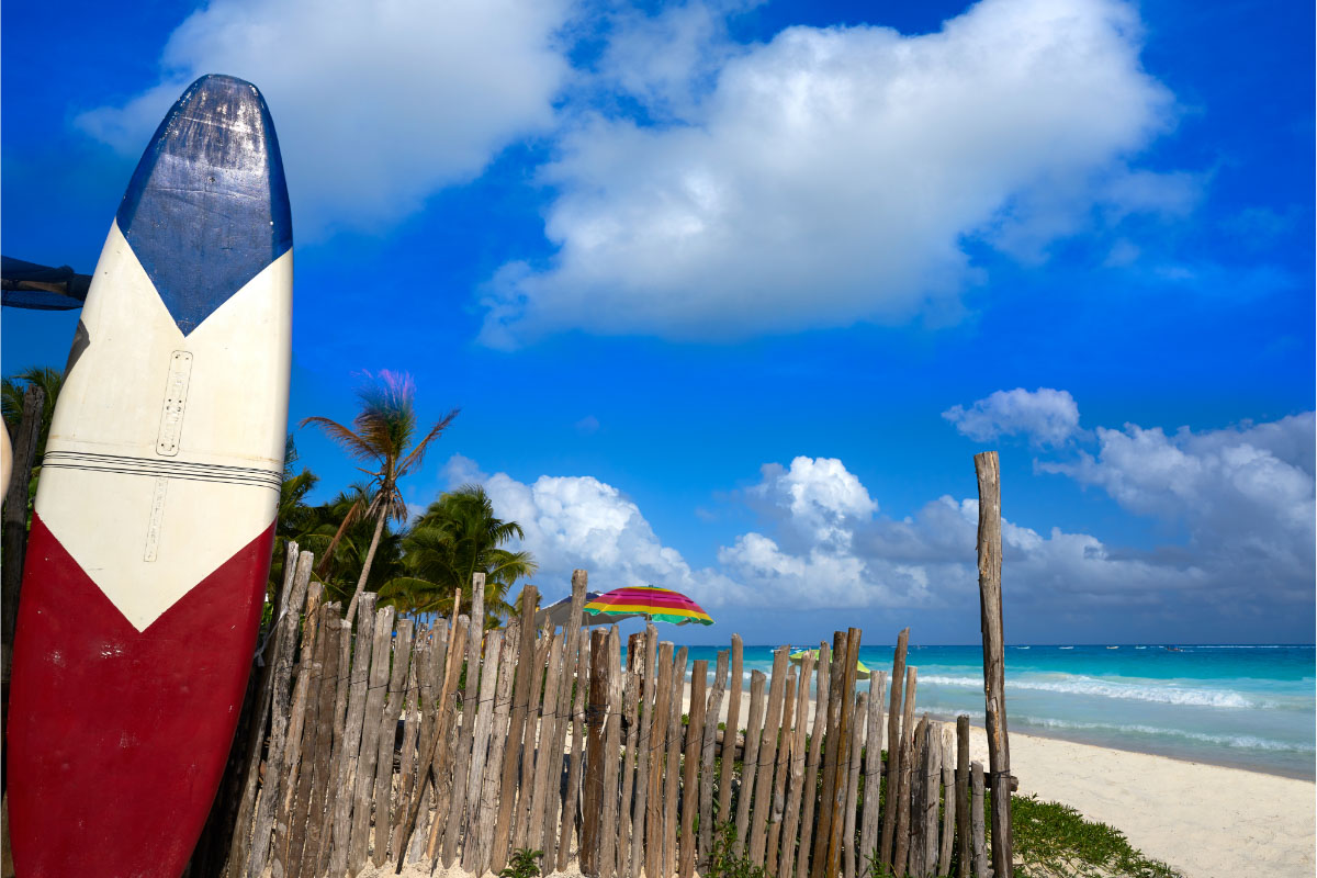 surfboard and beach in tulum